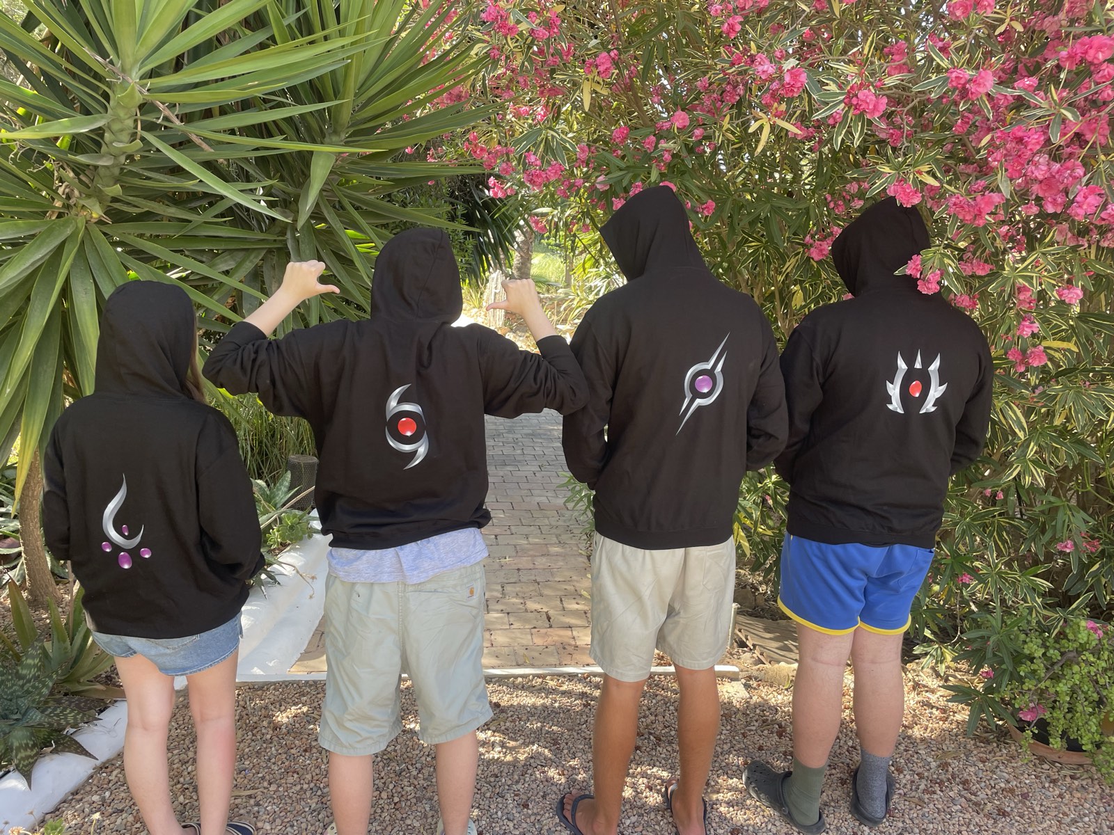 Four young people wearing Project Avatar attribute hoodies